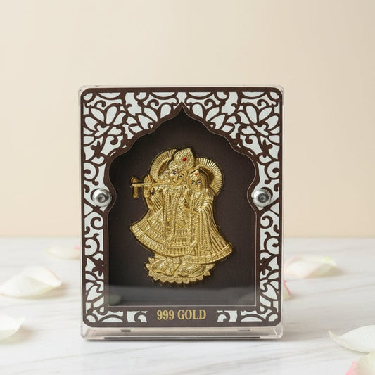 Gold figurine in an ornate black frame on a white surface with 'KANUVEDA' branding.