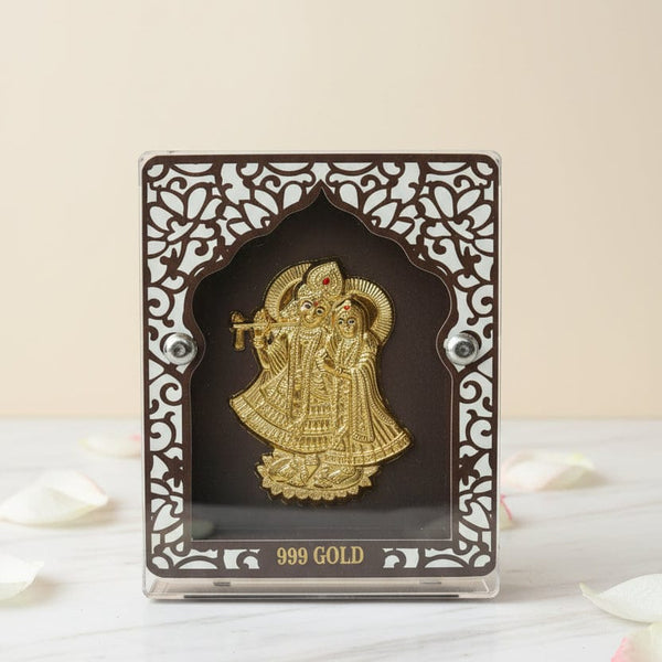 Gold figurine in an ornate black frame on a white surface with 'KANUVEDA' branding.